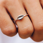 Person wearing a Pura Vida Cowrie Shell Ring available at Be Charmed