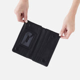 Black HOBO wallet with card slots held open by hands on a white background