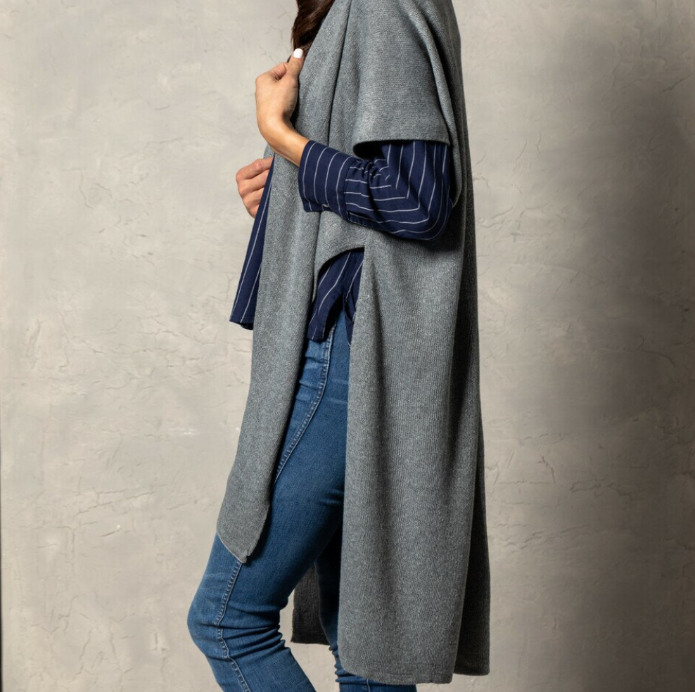 Pictured on woman Demdaco Recycled Knit Duster, soft eco-friendly knit wrap in neutral tones, perfect for layering—Available at Be Charmed.