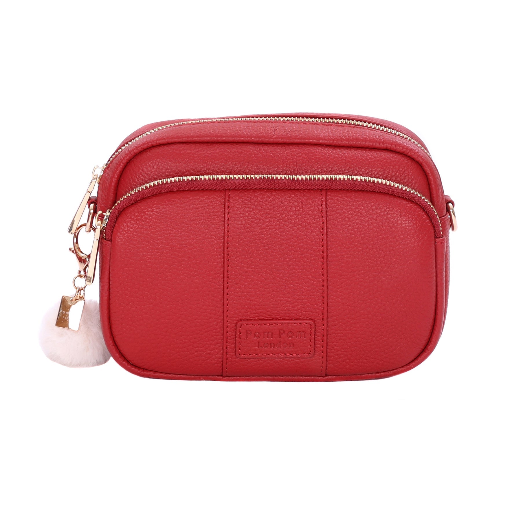 Crimson Red Pom Pom London Original Bag – classic handcrafted leather crossbody with adjustable and interchangeable straps. Available at Be Charmed.