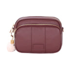 Deep Burgandy Pom Pom London Original Bag – classic handcrafted leather crossbody with adjustable and interchangeable straps. Available at Be Charmed.