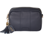 Navy Pom Pom London City Bag – handcrafted leather crossbody with interchangeable straps and London-inspired design. Available at Be Charmed.