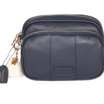Navy Pom Pom London Original Bag – classic handcrafted leather crossbody with adjustable and interchangeable straps. Available at Be Charmed.