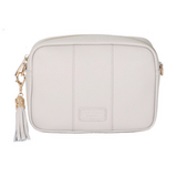 Oatmeal Pom Pom London City Bag – handcrafted leather crossbody with interchangeable straps and London-inspired design. Available at Be Charmed.