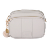 Oatmeal Pom Pom London Original Bag – classic handcrafted leather crossbody with adjustable and interchangeable straps. Available at Be Charmed.