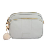 Pom Pom London Original leather crossbody bag with three zip compartments and gold hardware available at Be Charmed.