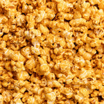 Close-up of a pile of poppy pimento cheese popcorn. Available at Be Charmed. 
