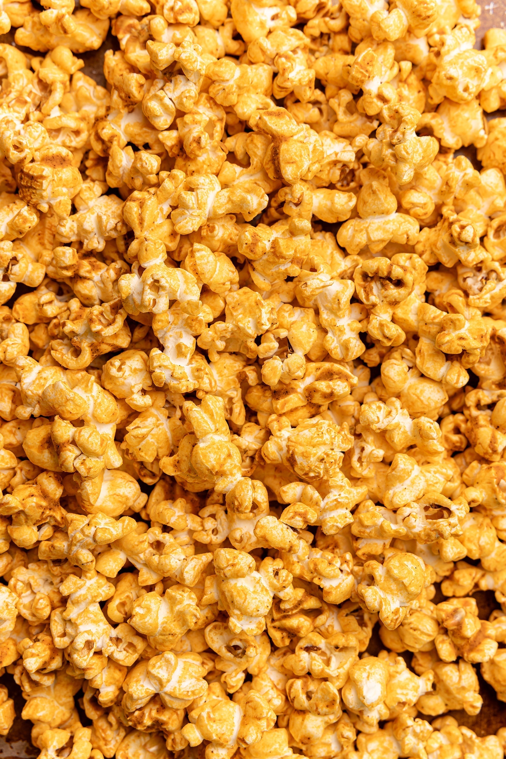 Close-up of a pile of poppy pimento cheese popcorn. Available at Be Charmed. 