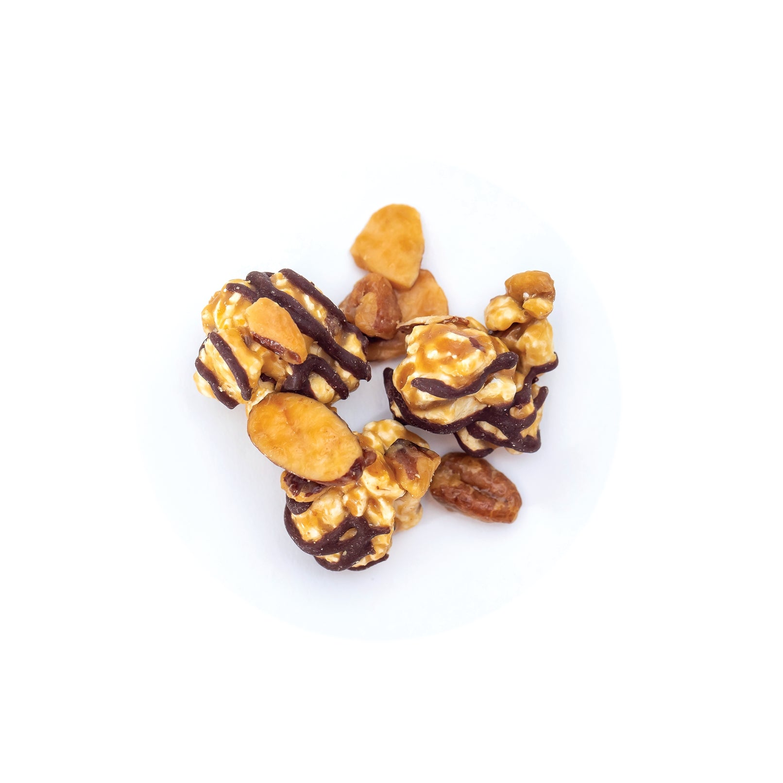Caramel corn with chocolate drizzle and almonds on a white background. Available at Be Charmed. 