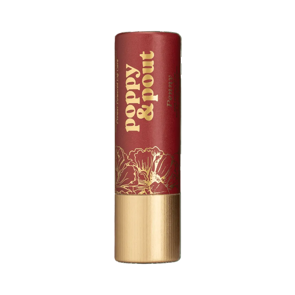  Poppy & Pout Penny Lip balm with gold text and floral design on a background. Available at Be Charmed