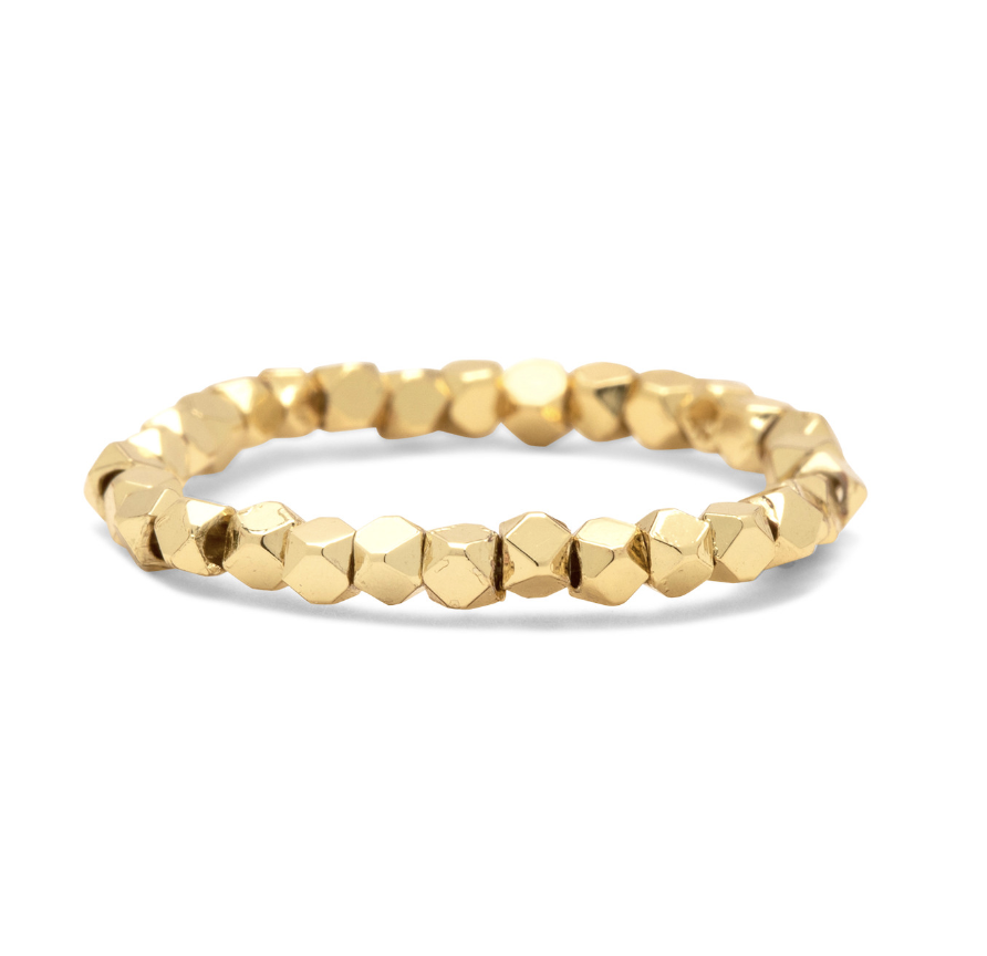 A {ura Vida gold faceted bead stretch ring on a white background. Available at Be Charmed
