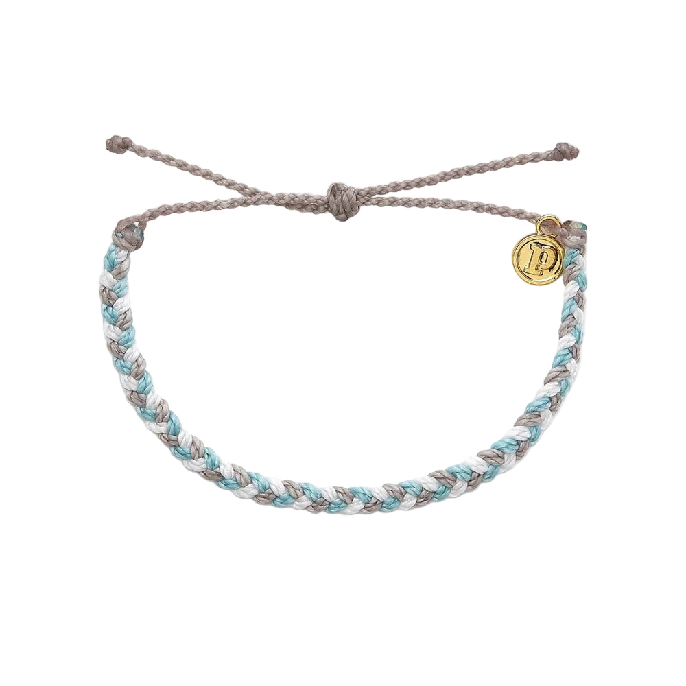 A Pura Vida braided bracelet with gold-coated 'P' charm, adjustable in diameter. Available at Be Charmed