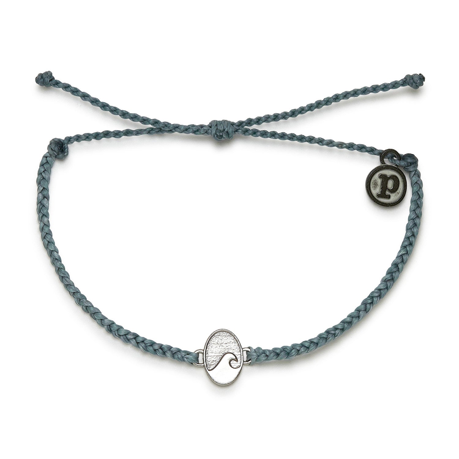 A smoke blue Pura Vida charm bracelet with a wave-shaped charm and a Pura Vida logo tag. Available at Be Charmed