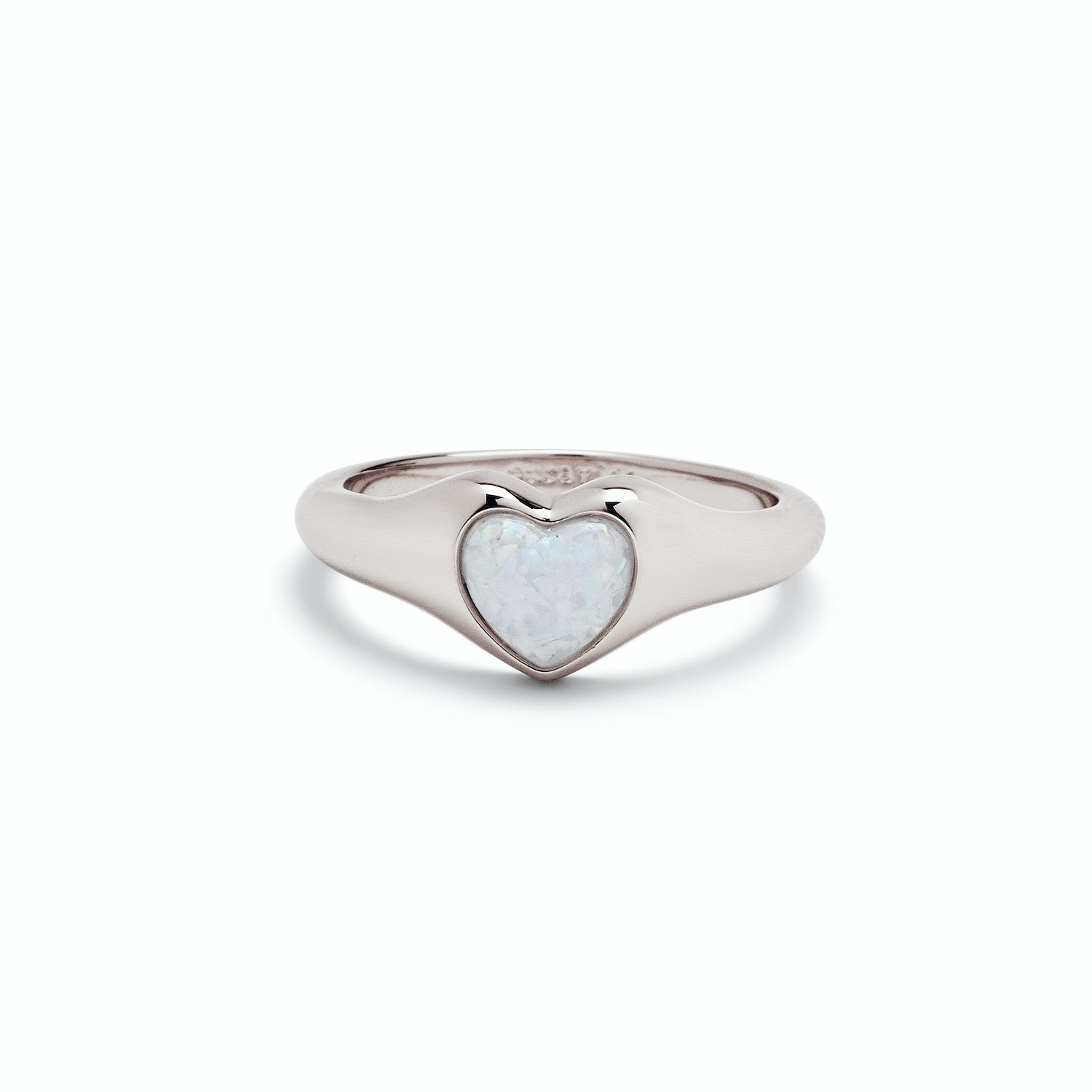 A silver-colored Pura VIda signet ring with a heart-shaped white opal stone set in the center. Available at Be Charmed