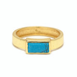 A gold Pura Vida ring with a turquoise stone in a geometric setting, giving a vibrant and tropical vibe. Available at Be Charmed