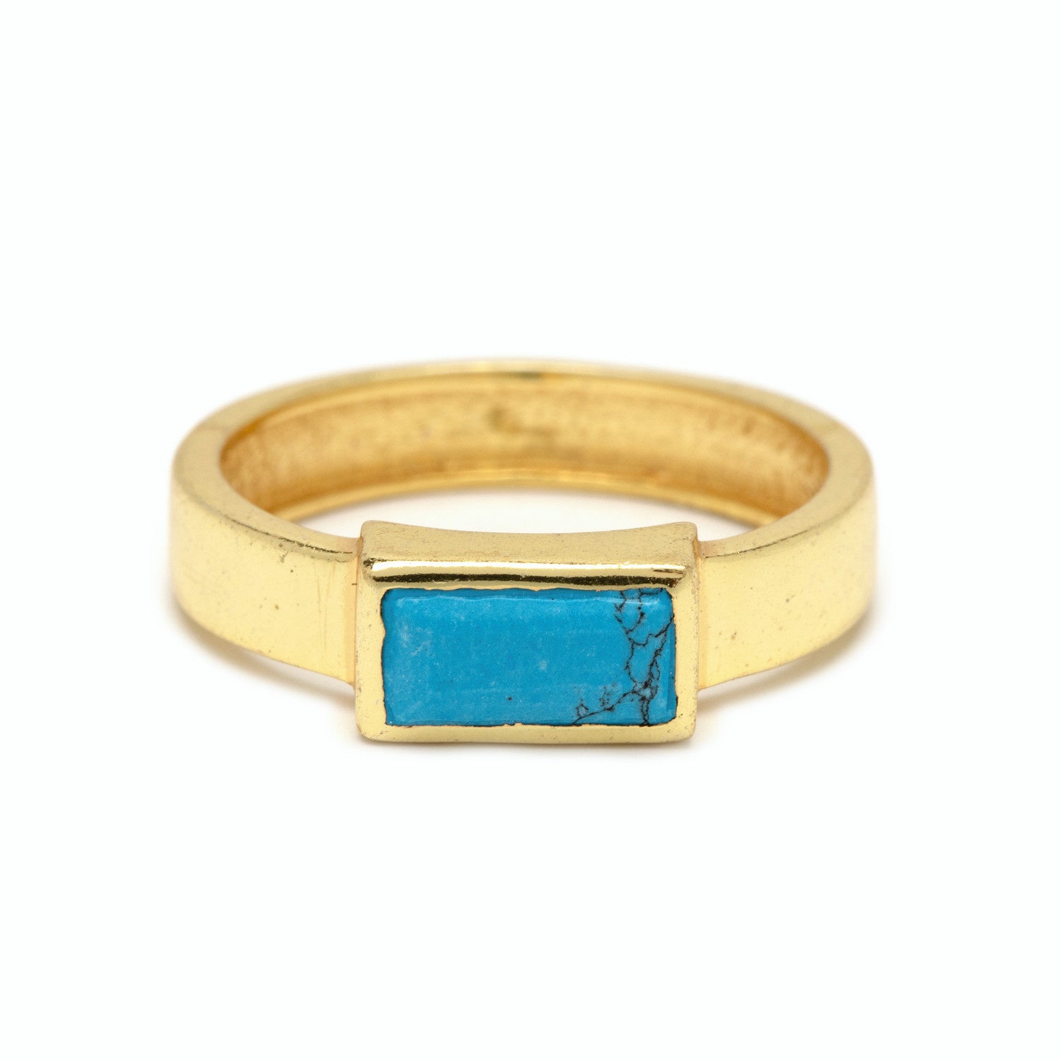 A gold Pura Vida ring with a turquoise stone in a geometric setting, giving a vibrant and tropical vibe. Available at Be Charmed