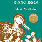 Book cover of 'Make Way for Ducklings' by Robert McCloskey with a teal background and illustration of ducks. Available at Be Charmed