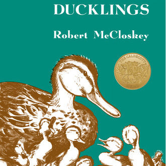 Book cover of 'Make Way for Ducklings' by Robert McCloskey with a teal background and illustration of ducks. Available at Be Charmed