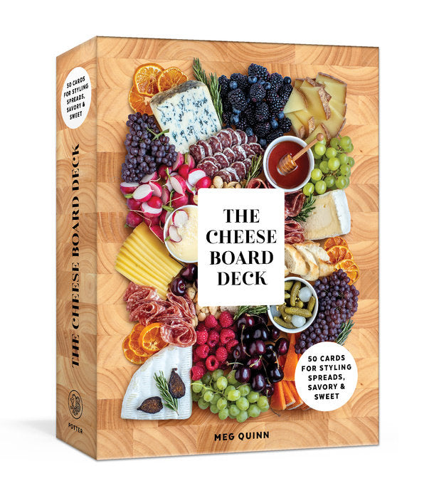 Book titled 'The Cheese Board Deck' by Meg Quinn with a wooden board design on the cover. Available at Be Charmed. 