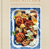 Book cover of 'The Lost Kitchen' with a dish of grilled peaches and honey on a beige background. Available at Be Charmed.  