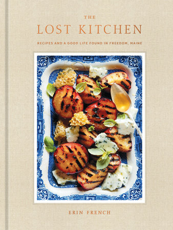 Book cover of 'The Lost Kitchen' with a dish of grilled peaches and honey on a beige background. Available at Be Charmed.  
