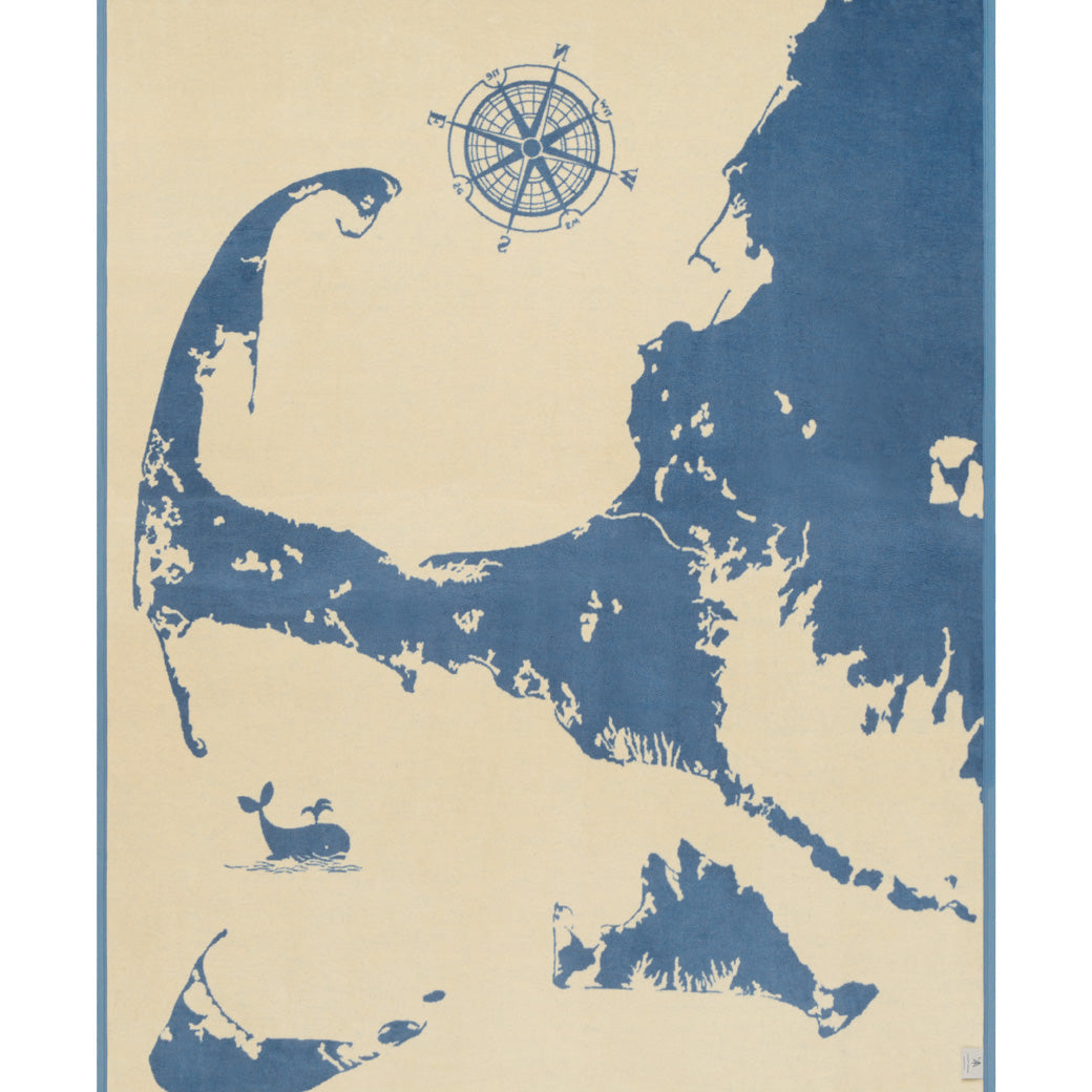 Reverse side of ChappyWrap Cape and Islands Map Blanket with a detailed illustration of Cape Cod, Martha’s Vineyard, and Nantucket in calming ocean hues. Crafted in a soft, durable cotton blend—ideal for beach homes or New England lovers. Available at Be Charmed.