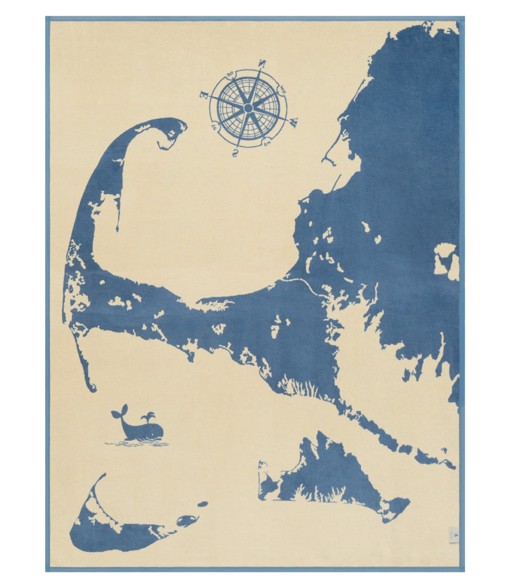 Reverse side of ChappyWrap Cape and Islands Map Blanket with a detailed illustration of Cape Cod, Martha’s Vineyard, and Nantucket in calming ocean hues. Crafted in a soft, durable cotton blend—ideal for beach homes or New England lovers. Available at Be Charmed.