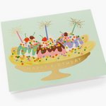 A colorful Rifle Paper Co. Banana Split birthday card with a cheerful, cherry-topped dessert illustration, available at Be Charmed.