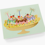 A colorful Rifle Paper Co. Banana Split birthday card with a cheerful, cherry-topped dessert illustration, available at Be Charmed.