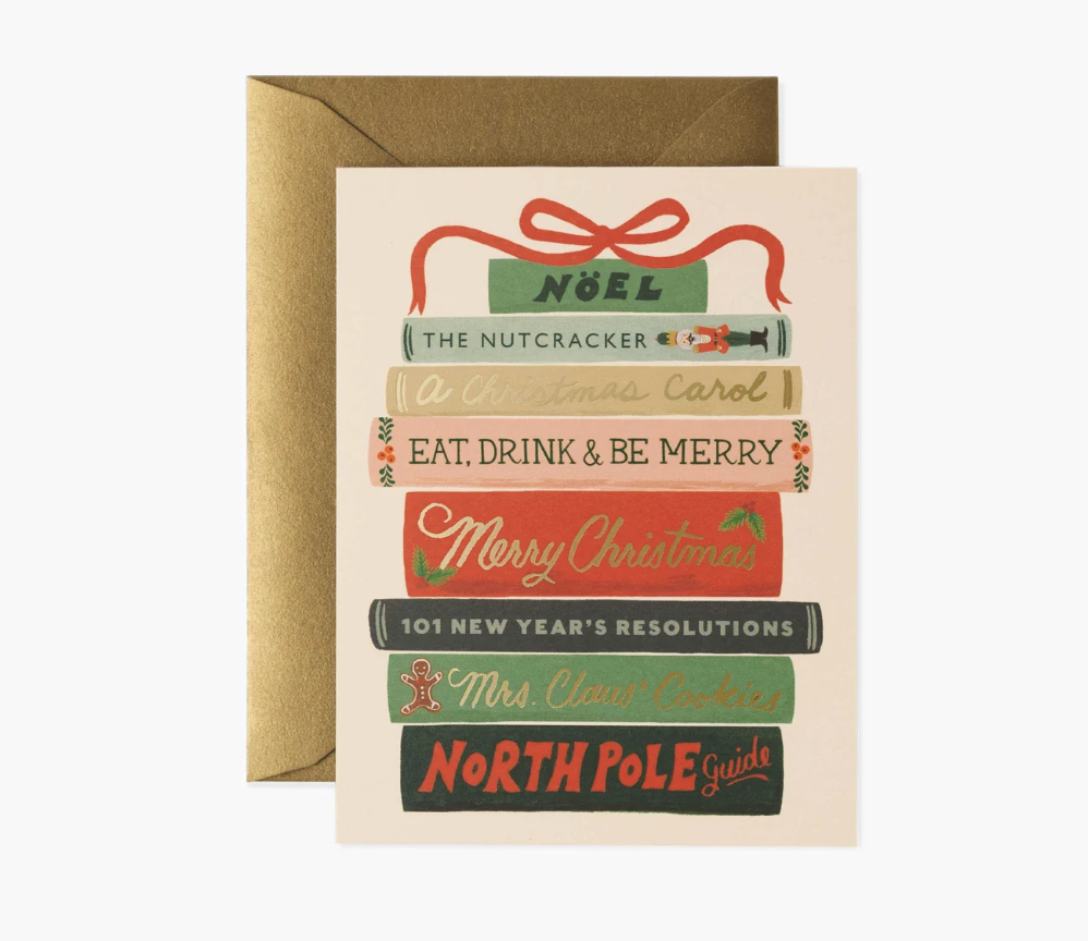 Christmas-themed greeting card with book design and envelope on a white background. Available at Be Charmed