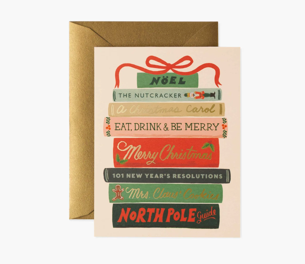 Christmas-themed greeting card with book design and envelope on a white background. Available at Be Charmed