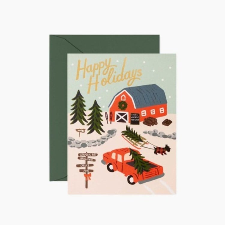 Holiday card with a red barn, Christmas trees, and a red truck on a white background. Available at Be Charmed