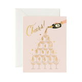 Shop the Rifle Paper Co. Champagne Tower cheers card at Be Charmed. This elegant, foil-accented card is perfect for any celebration.