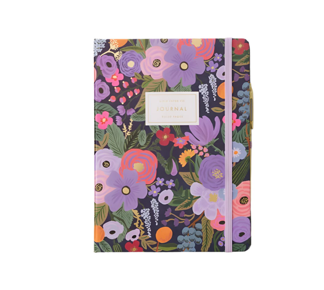 A hardcover journal with a floral pattern and a gold band where the title 'JOURNAL' is written. Available at Be Charmed