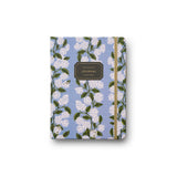 A blue journal with a hydrangea floral pattern and a gold elastic closure. Available at Be Charmed