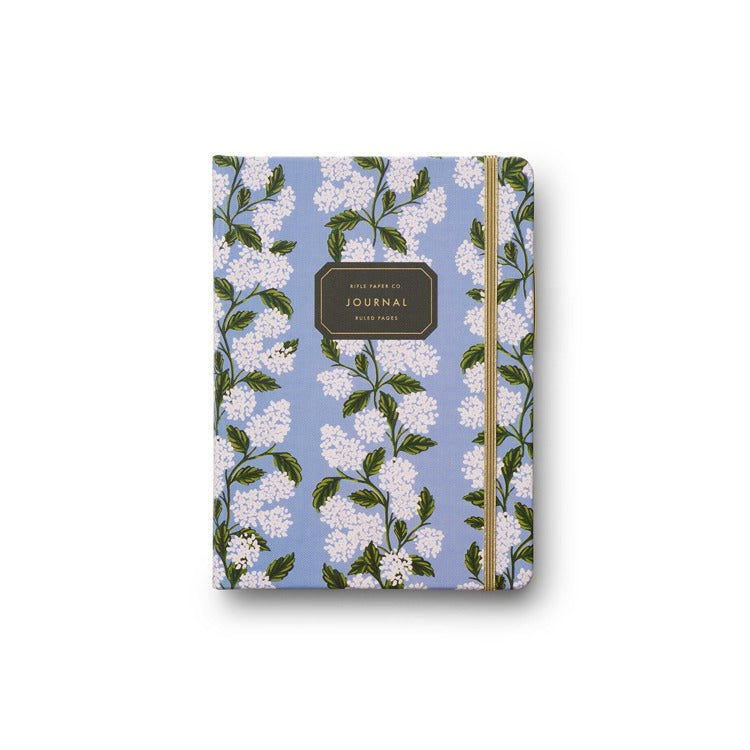 A blue journal with a hydrangea floral pattern and a gold elastic closure. Available at Be Charmed