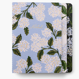 A set of three Hydrangea Rifle Paper Co. stitched notebooks with vibrant floral illustrations, available at Be Charmed.