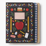 A School themed notebook with a black cover decorated with a colorful floral border, red apple, yellow pencils, and school supplies. The notebook is shown closed with its patterned paper covers partially visible on the right side. Available at Be Charmed