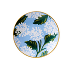 A porcelain ring dish with a gold rim featuring a floral pattern of hydrangeas. Available at Be Charmed