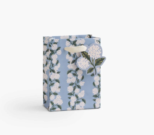 A premium Rifle Paper Co. small gift bag featuring hand-painted pink hydrangea florals and soft ribbon handles, available at Be Charmed.