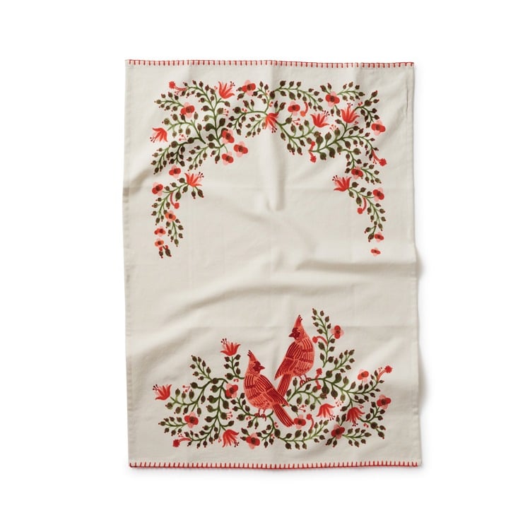 Christmas tea towel featuring cardinal birds and holly motifs in red and gold—Available at Be Charmed