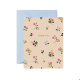 Floral patterned card with 'Thank You' text and a light blue envelope on a white background.  Available at Be Charmed