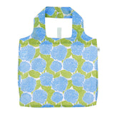 Rock Flower Paper Blue Hydrangea Reusable shopping bag with blue floral pattern on a white background. Available at Be Charmed