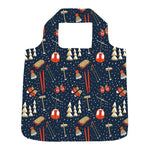 A reusable folding shopping bag with a dark navy blue background and a winter ski pattern featuring red gondolas, orange ski boots, white pine trees, and skis, shown on a plain white background. Available at Be Charmed