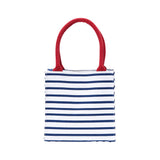 Striped tote bag with red handles on a white background. Available at Be Charmed
