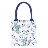 A white fabric tote bag with a blue and green berry leaf pattern and dark blue handles, shown against a plain white background. Available at Be Charmed