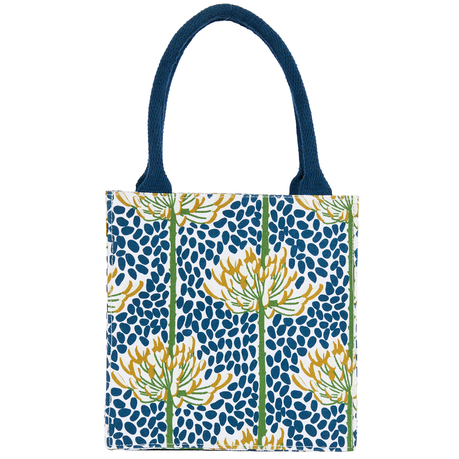 A tote bag with dark blue handles and a blue, yellow, and green botanical pattern on a white background. Available at Be Charmed