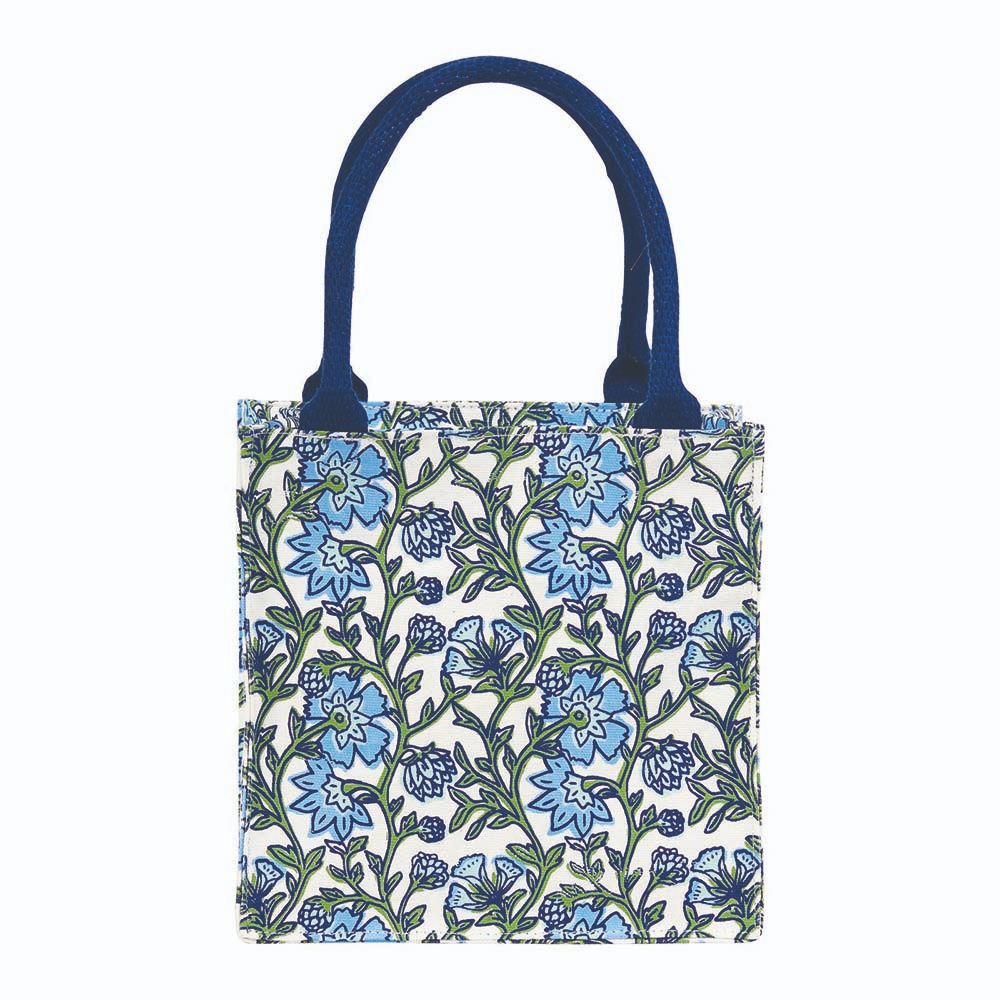 Floral patterned tote bag with blue handles on a white background. Available at Be Charmed