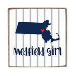 Decorative sign with a map of Massachusetts, a red heart, and 'Medfield Girl' text on a striped background. Available at Be Charmed