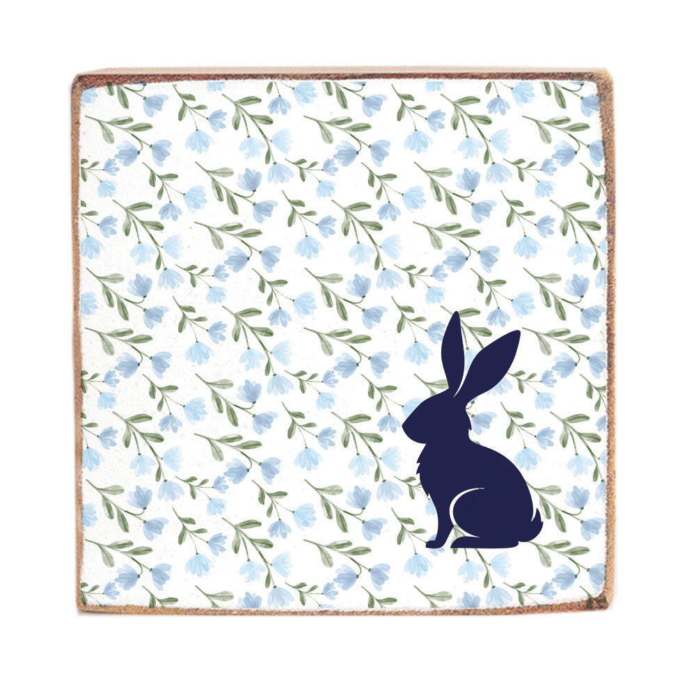 A Rustic marlin wooden block sign with a blue floral pattern and a silhouette of a bunny on it. Available at Be Charmed